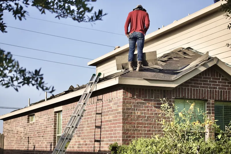 Professional roofer working on a residential roof in Vermont Square